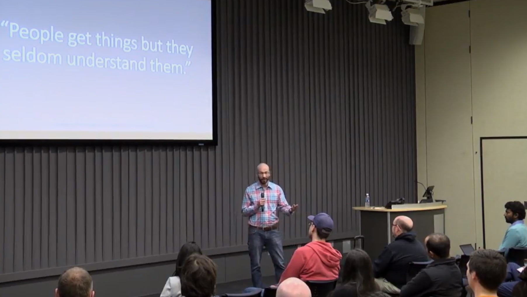 David speaking to a seated audience at Minnestar, a slide behind him reads: People get things but they seldom understand them.